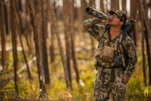 Elk hunter calling with a bugle tube