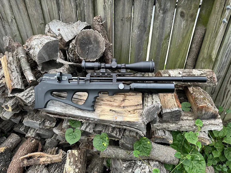 FX Wildcat MKIII air rifle sitting on a stack of wood