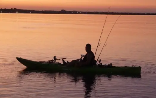 A man in a fishing kayak.