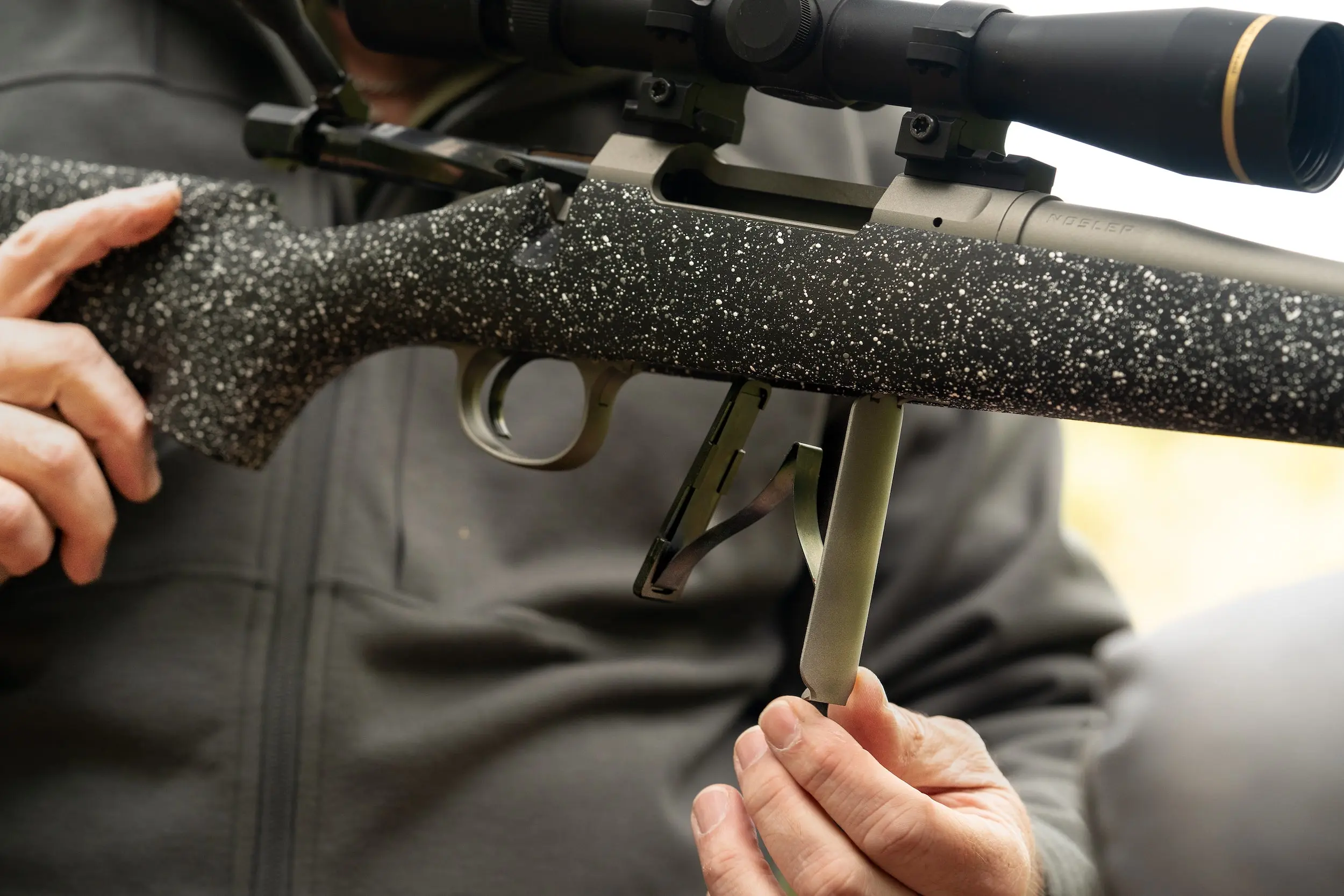 The hinged floor plate on the Nosler Model 21.