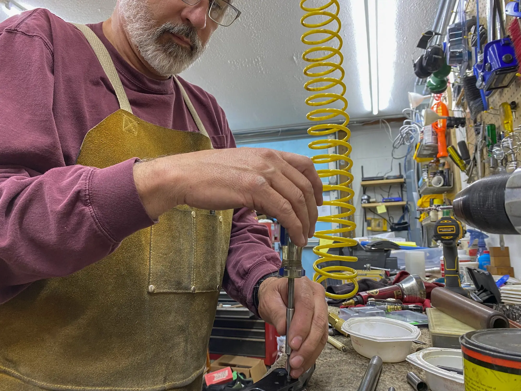 Man using a screwdriver on a workbench