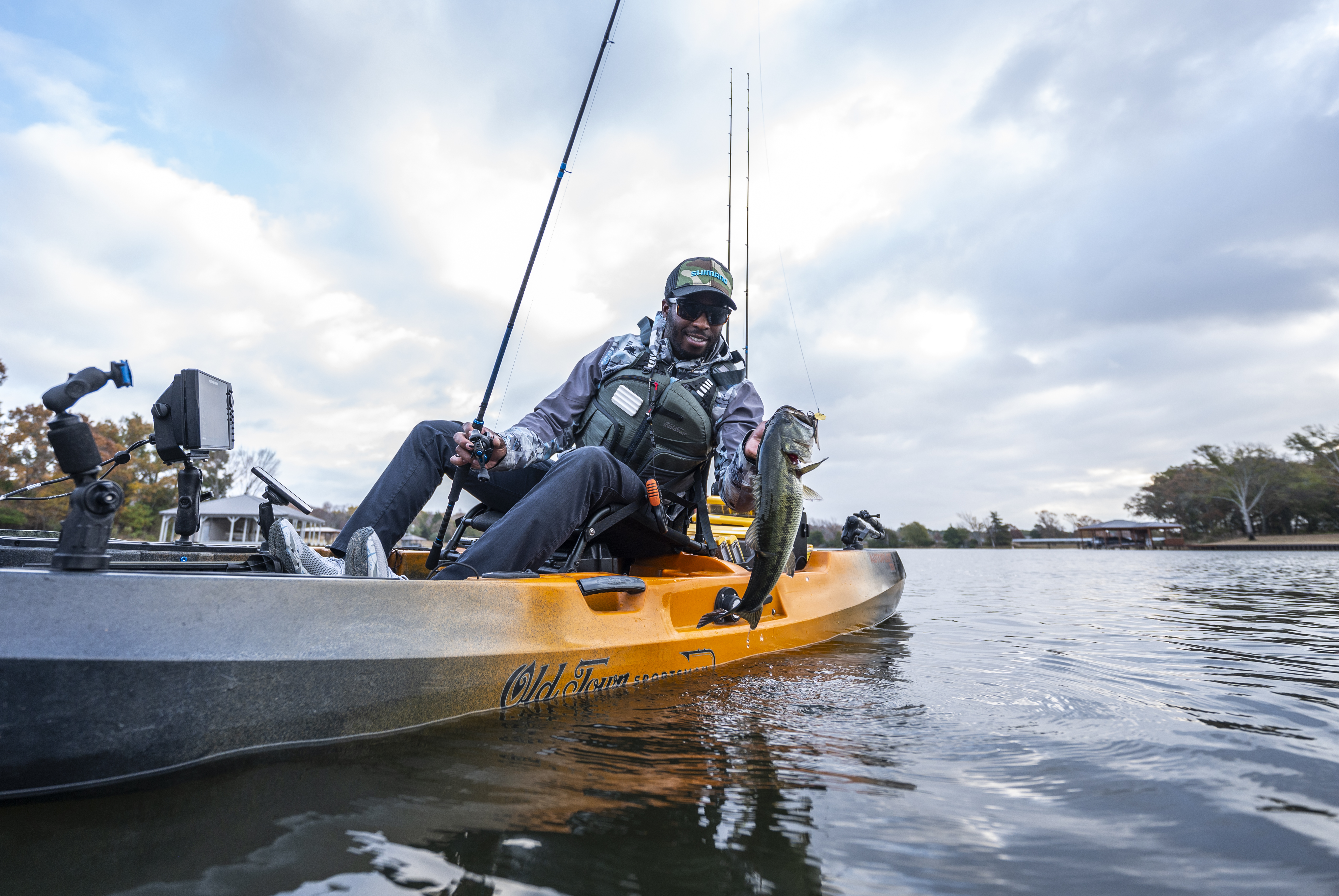 Angler in kayak holding bass