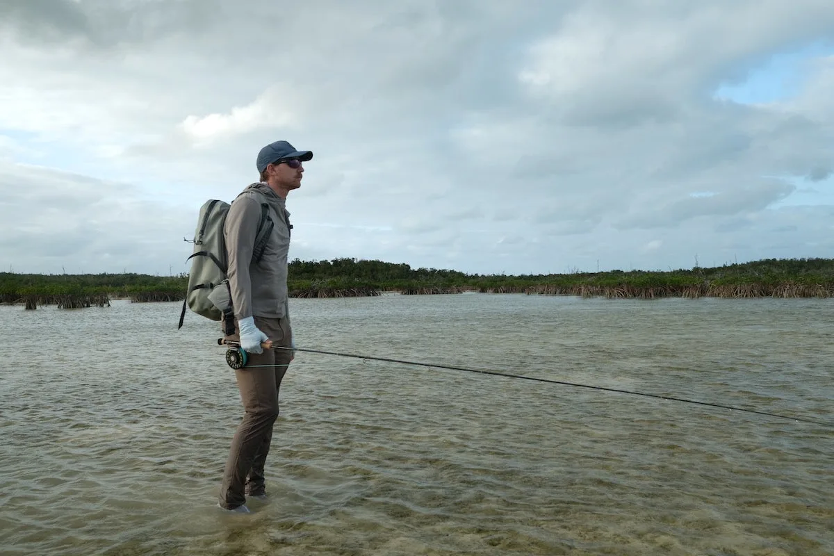 Angler fishing while wearing Free Fly Latitude Pant