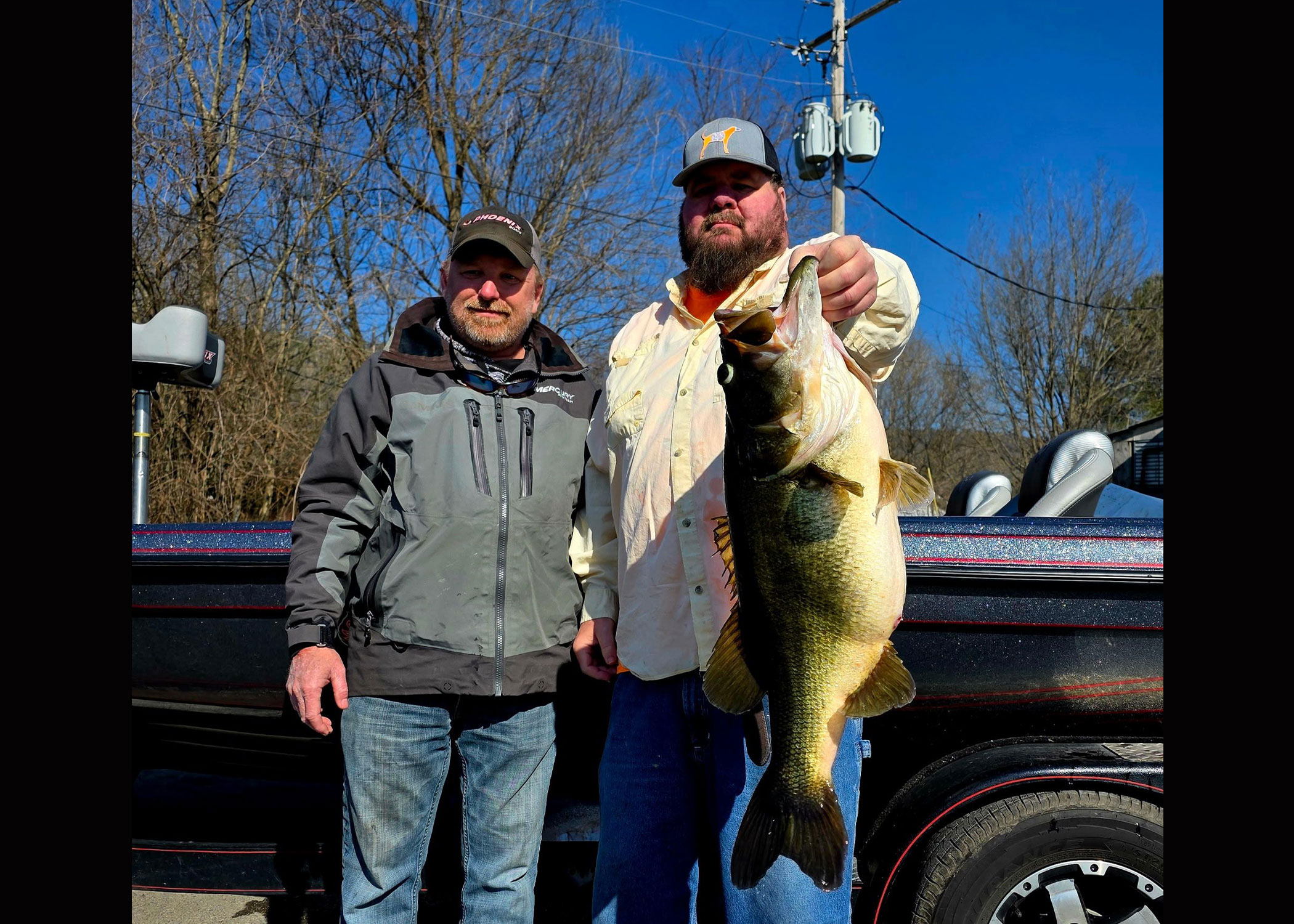 A Tennessee anglers poses with a pending state-record largemouth bass. 