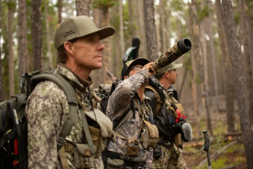 three elk hunters in the woods