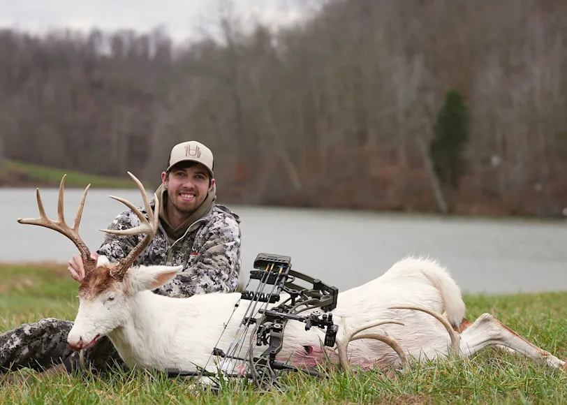 A bowhunter poses with a rare albino buck taken in Kentucky.