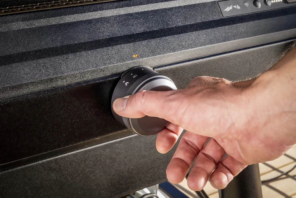 Person adjusting knob on Traeger Flatrock griddle