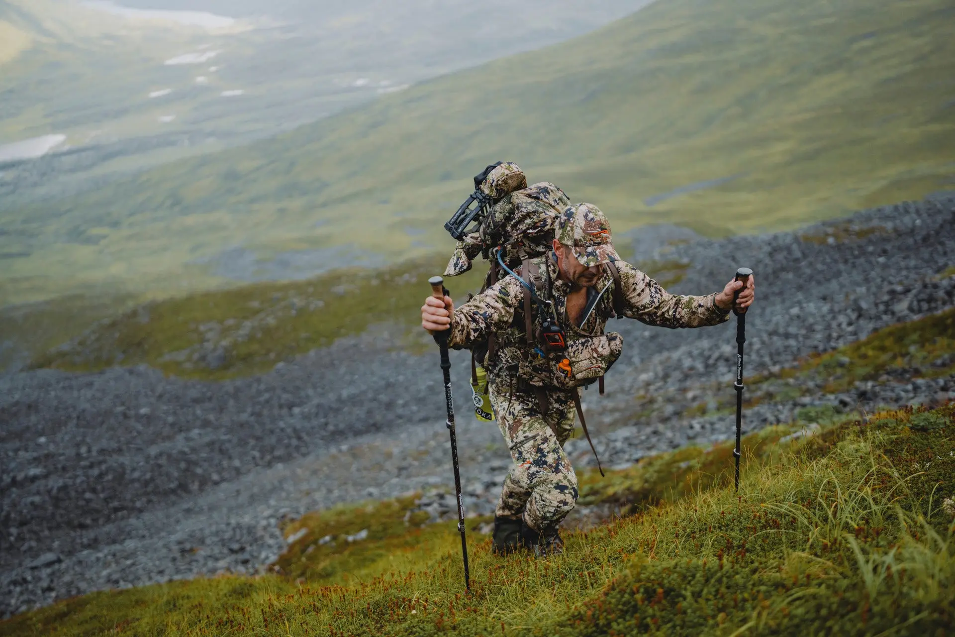 Photo of hunter climbing up a steep mountain to reflect the dangers of altitude sickness