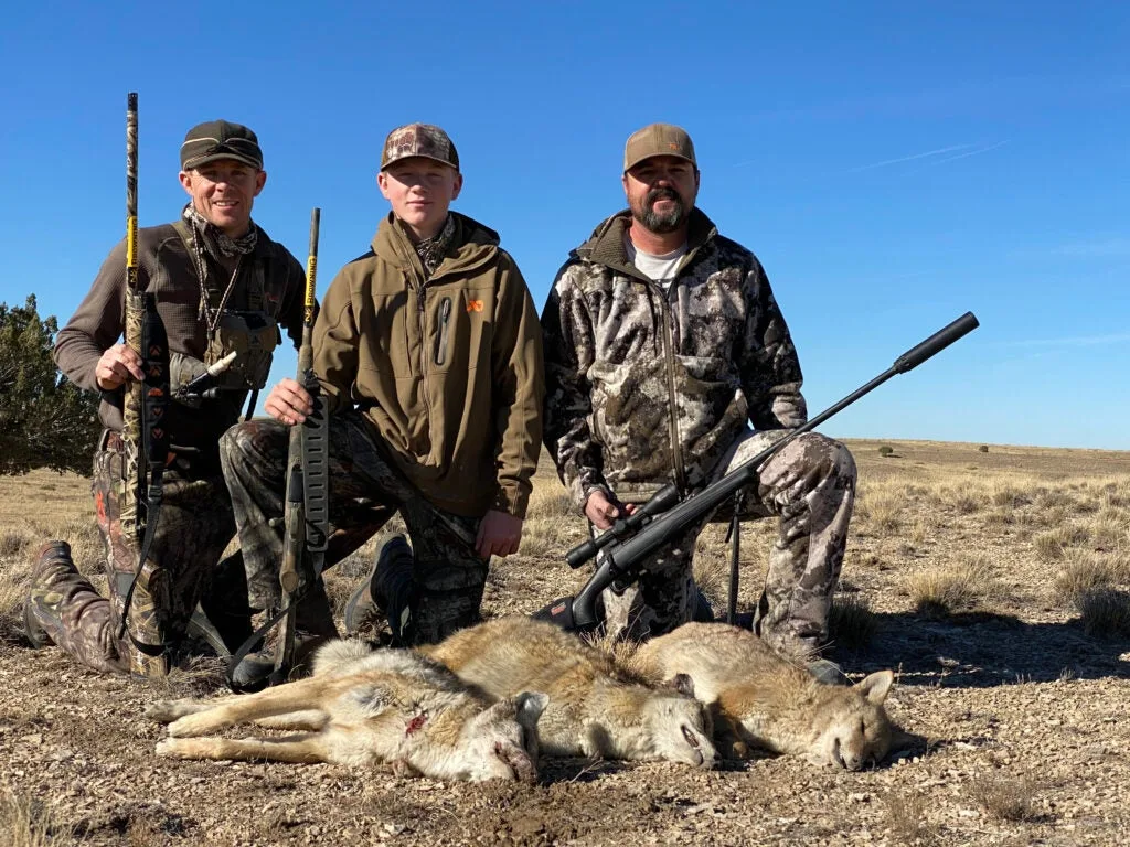 Hunters with three coyotes