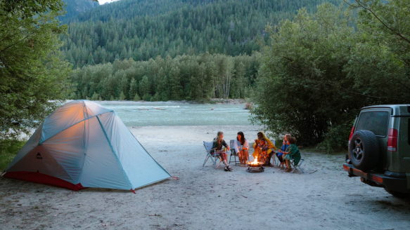 MSR tent set up at campsite near camp fire