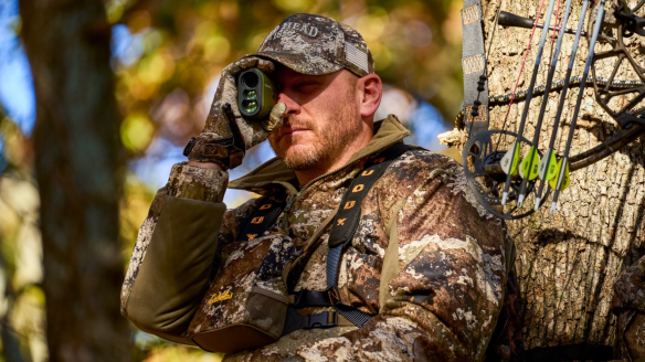 Bowhunter in tree wearing Cabela's Redhead hunting clothing