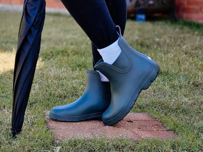 Woman wearing Totes Everywear Chelsea Rain Boots