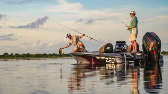 Two anglers fishing from Bass Pro Shops tracker boat