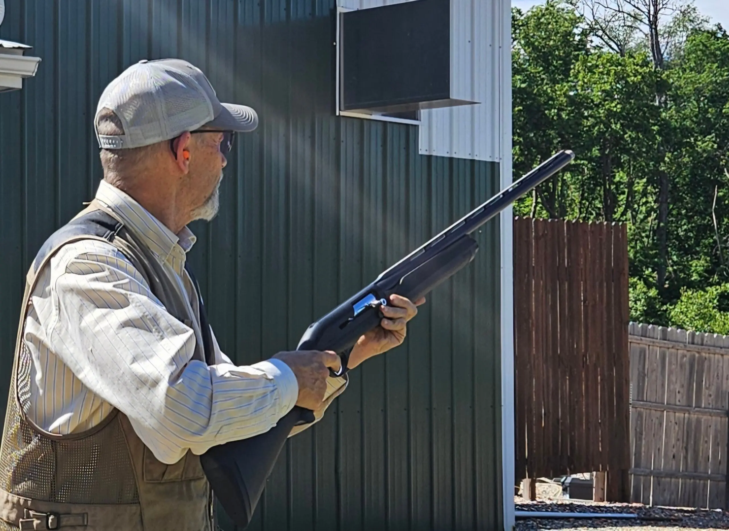 A shooter mounts the new Franchi Affinity 3 Sport Trap shotgun at a clay target range.