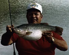 An angler poses with the Hawaiian state-record largemouth. 