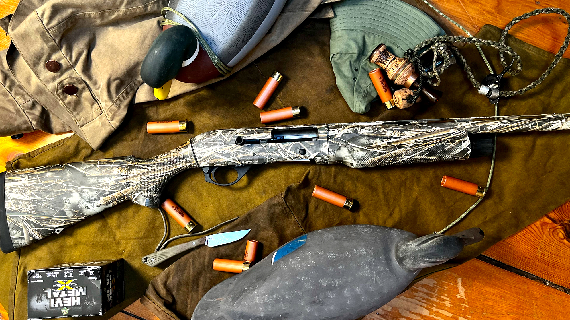 The new Spandau Arms S2 semi-auto shotgun on a wood surface with decoys and shells.