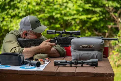 Man shooting from the bench with a rifle.