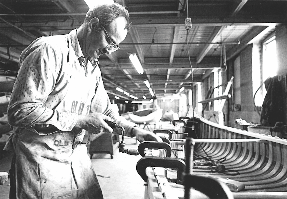 Old Town Factory worker building a canoe in the 1800s