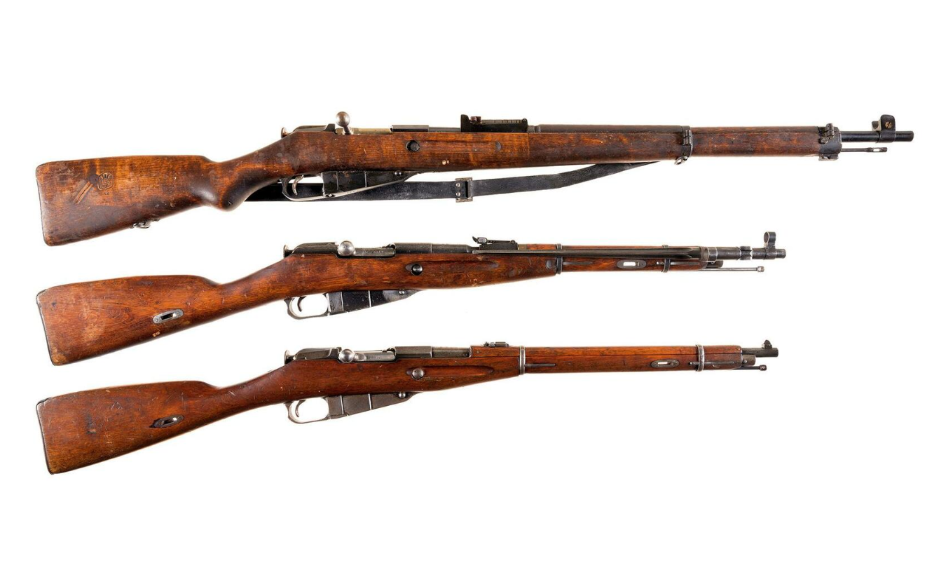 A full-sized Finish M39 variant of the Mosin-Nagant (top) above two Russian carbine-length Mosins.