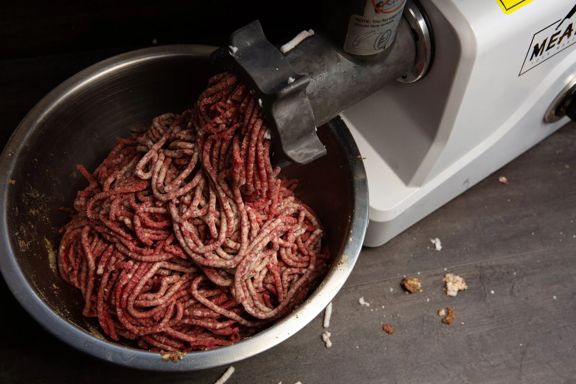 Meat going through a grinder.