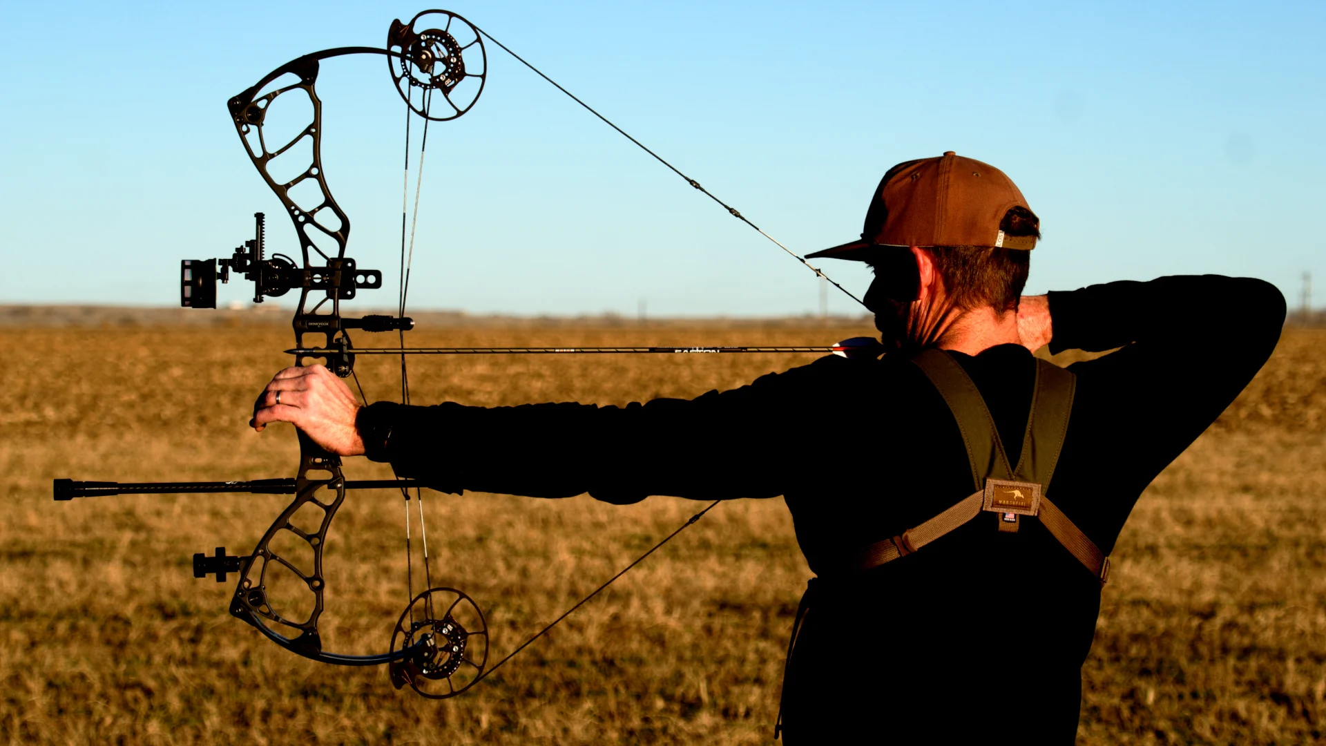 An archer shoots the new Bowtech Alliance compound bow on a range. 
