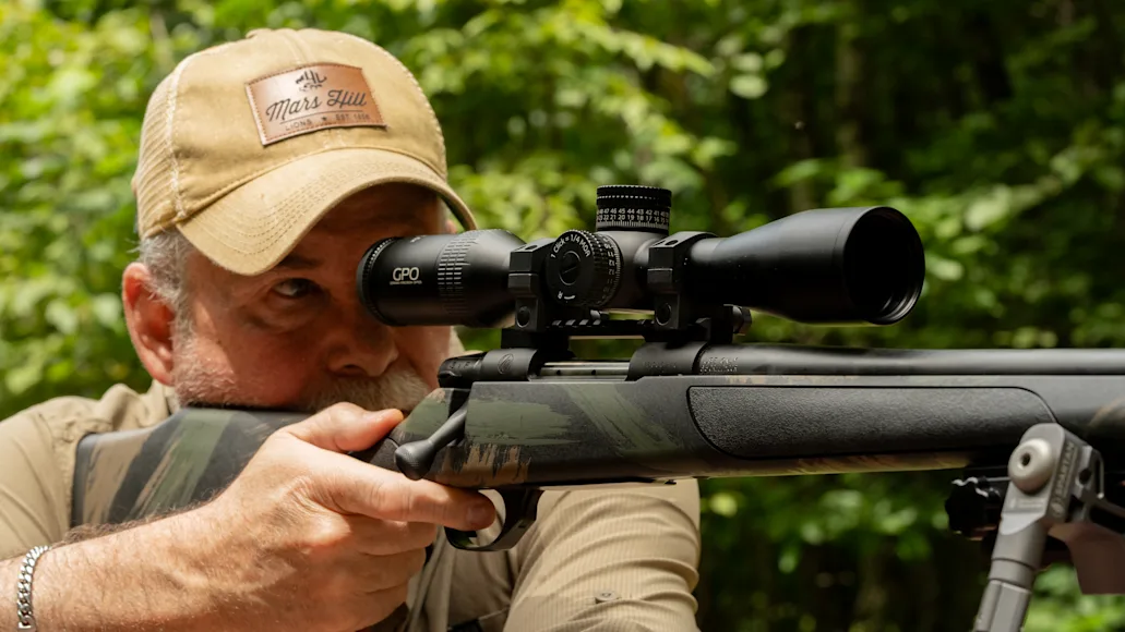 Shooter aims through a riflescope