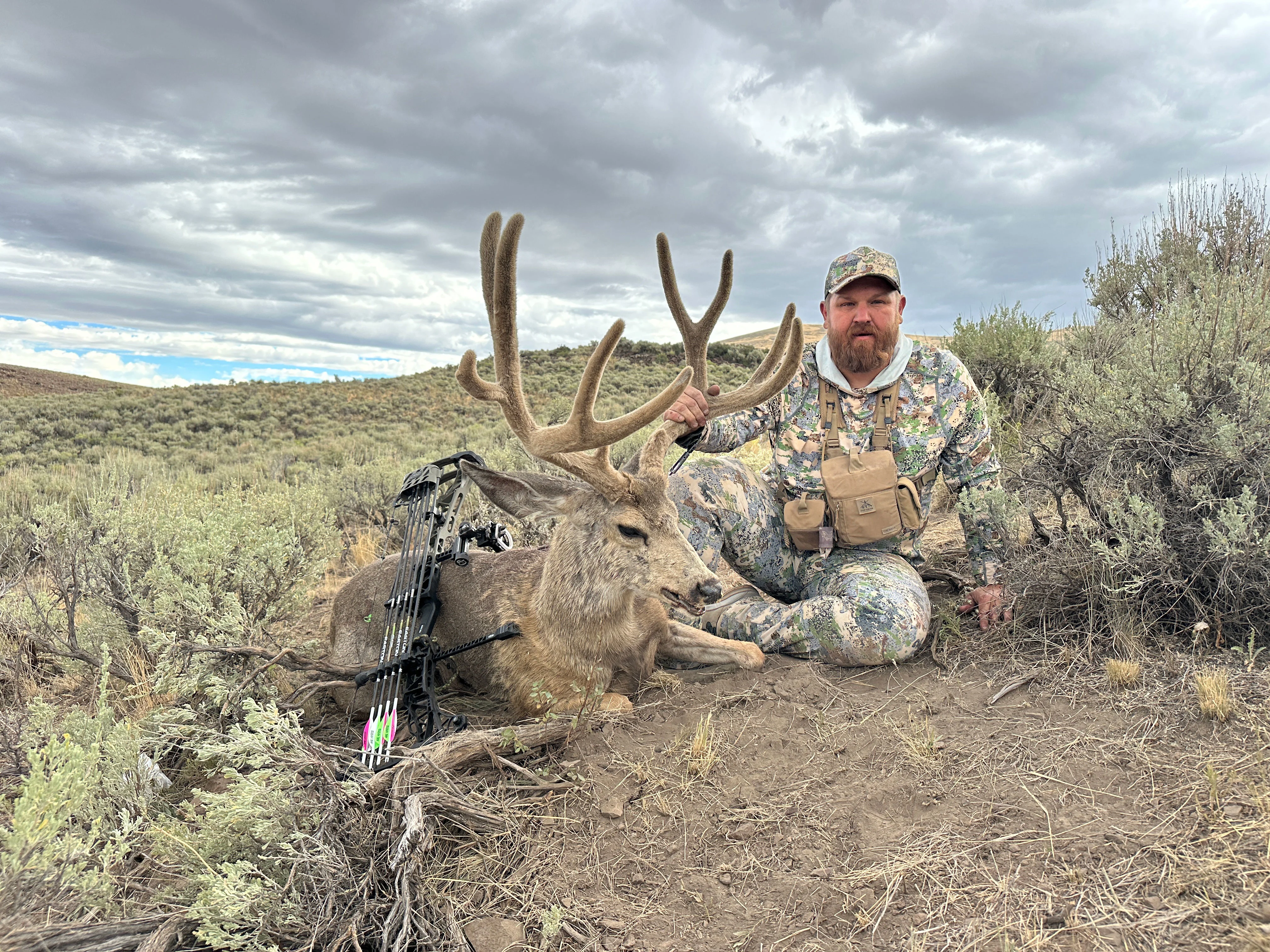 A hunter poses with a trophy mule deer taken in the desert Southwest. 