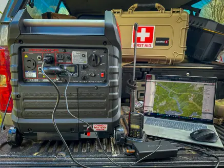 An inverter generator sits on a truck tailgate