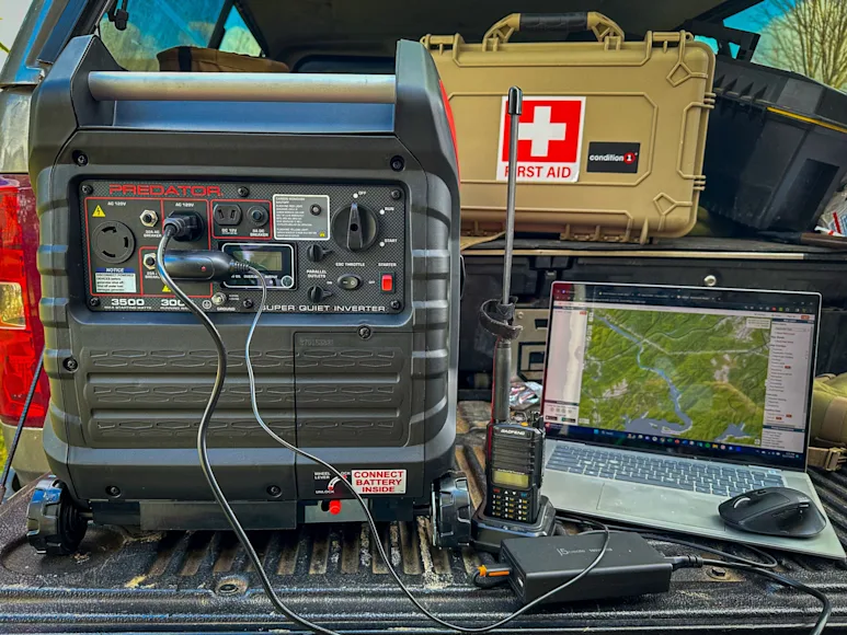 An inverter generator sits on a truck tailgate