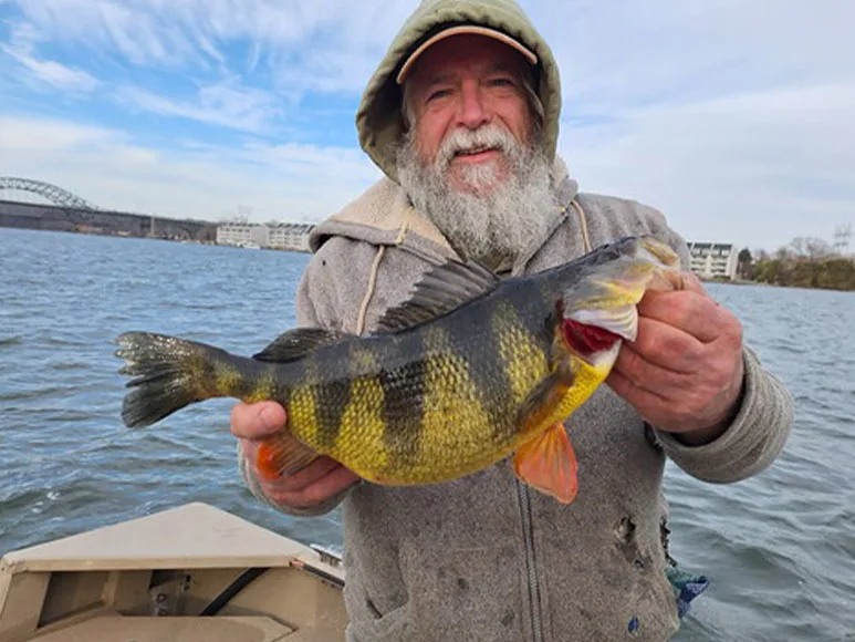 An angler poses with a record-breaking yellow perch caught in Maryland.