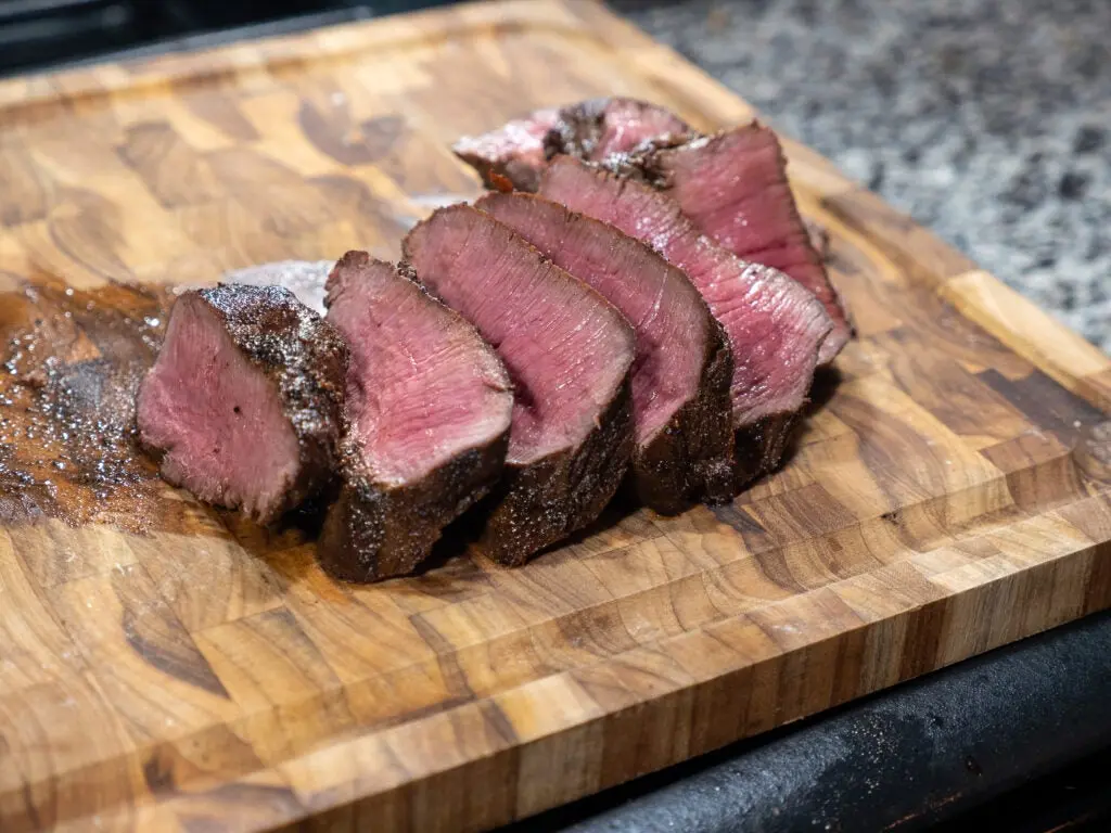 Sliced backstrap on a cutting board.