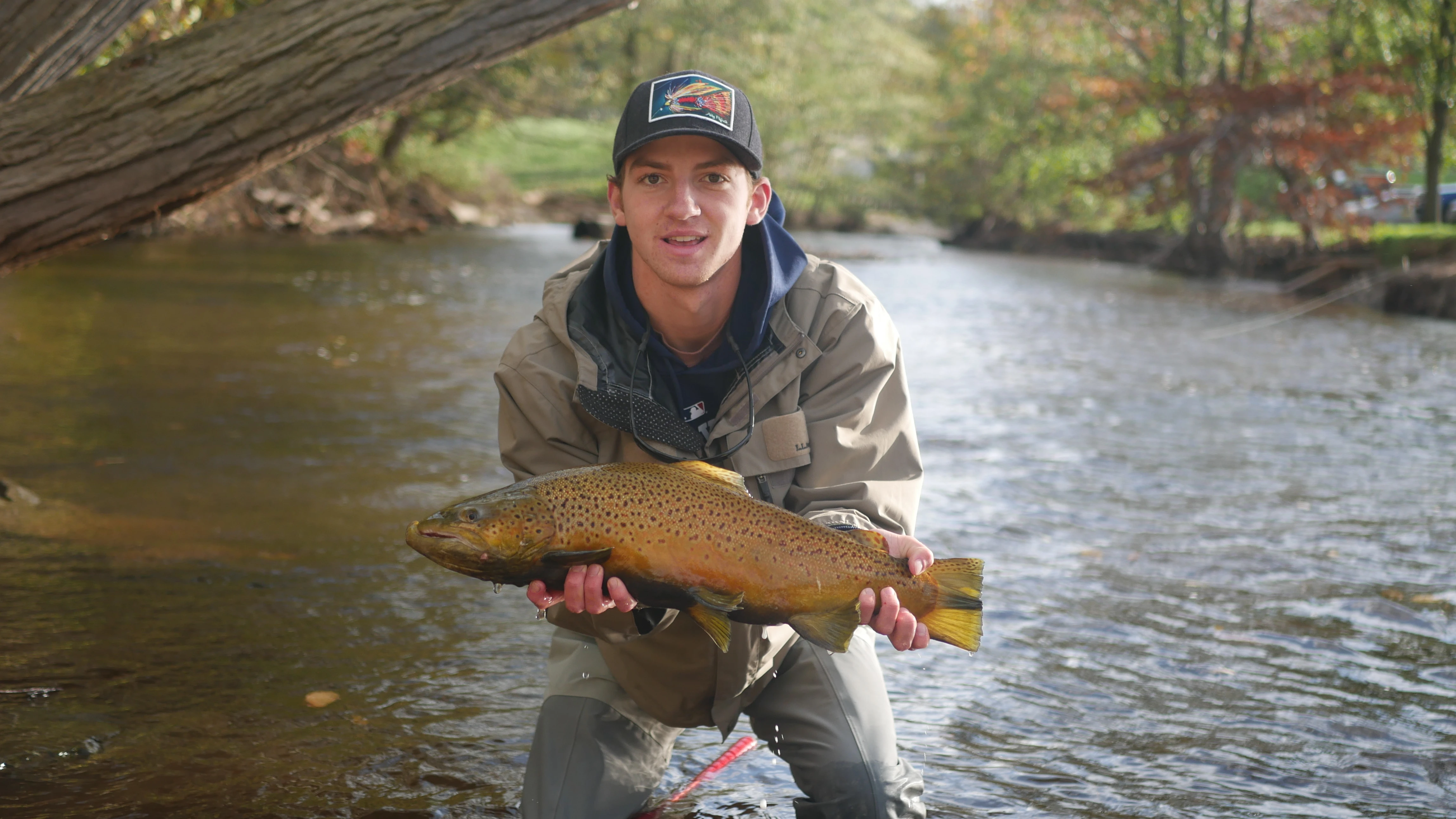 Angler holding up brown trout