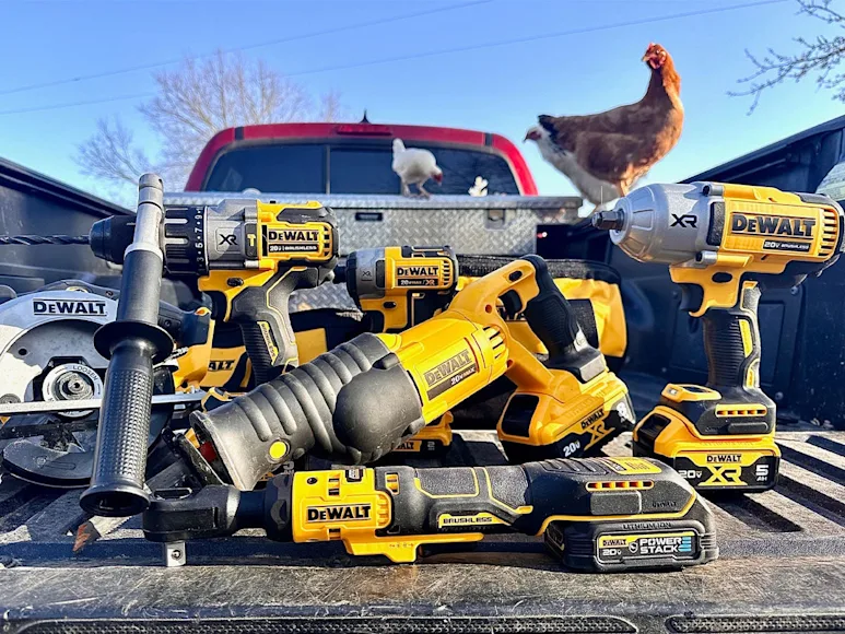 DeWalt power tools lined up on tailgate of pickup truck