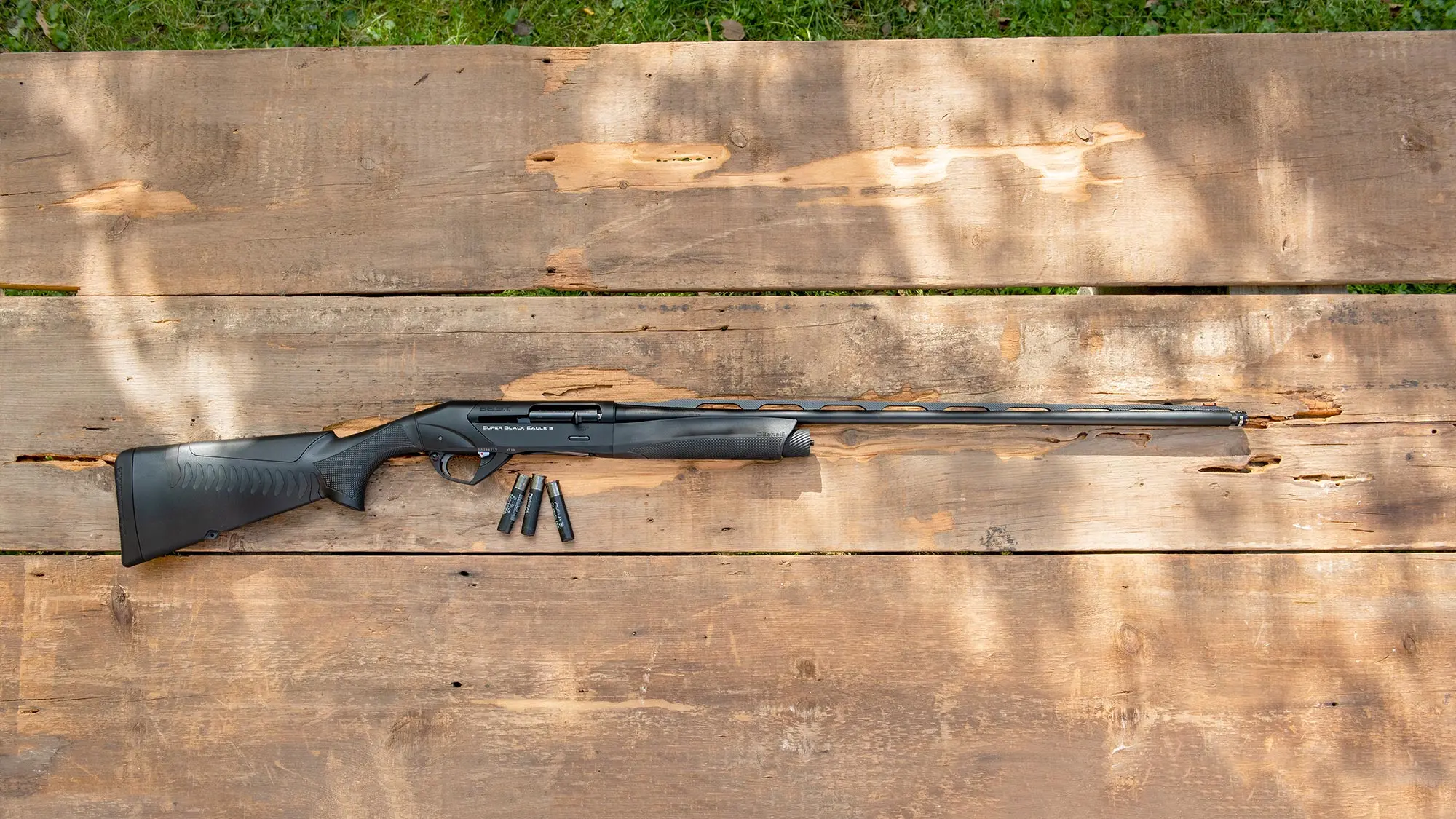 The new Benelli 28-gauge SBE3 BE S.T. shotgun lying on a table with shotgun shells.
