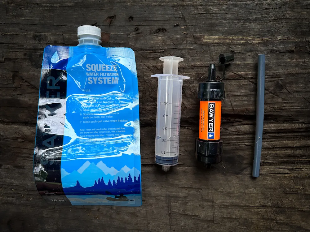 Sawyer Squeeze Water Filtration System on table during survival testing