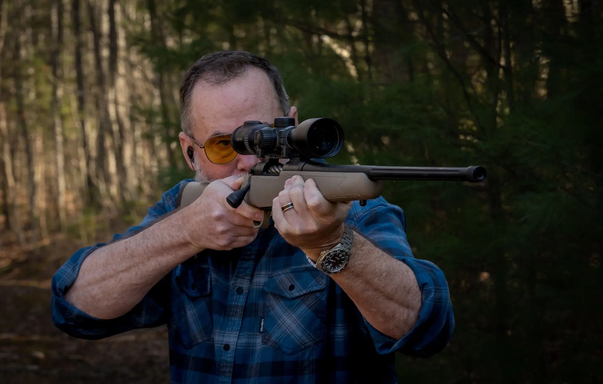 Man shooting a rifle.