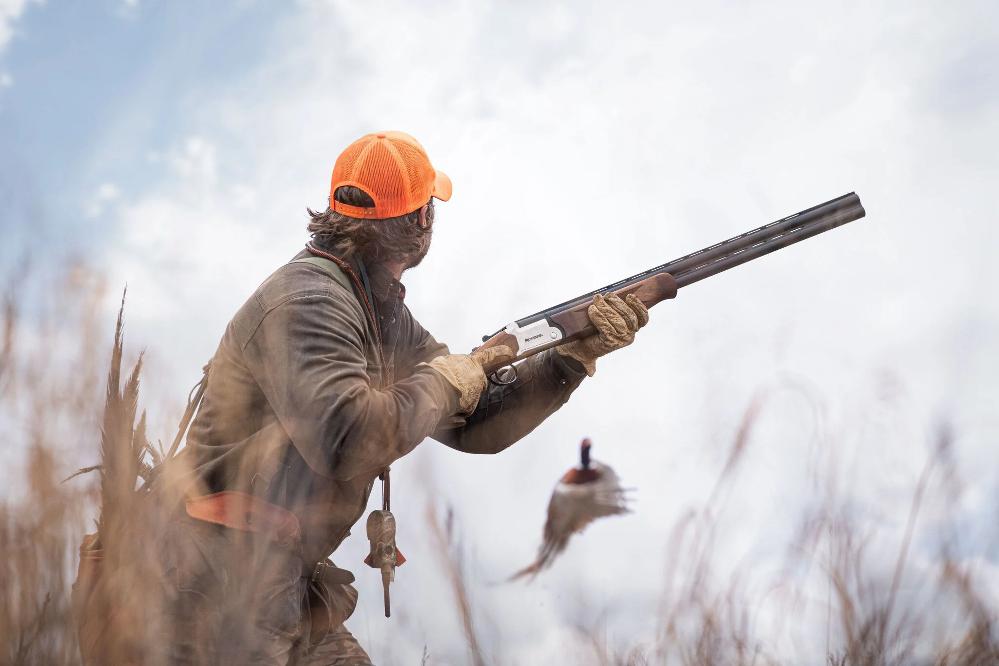 Hunter about to take a shot at a pheasant.