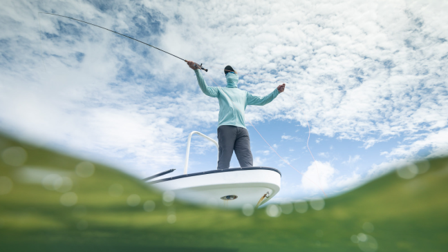 Angler fishing from front of boat wearing Grundens fishing gear