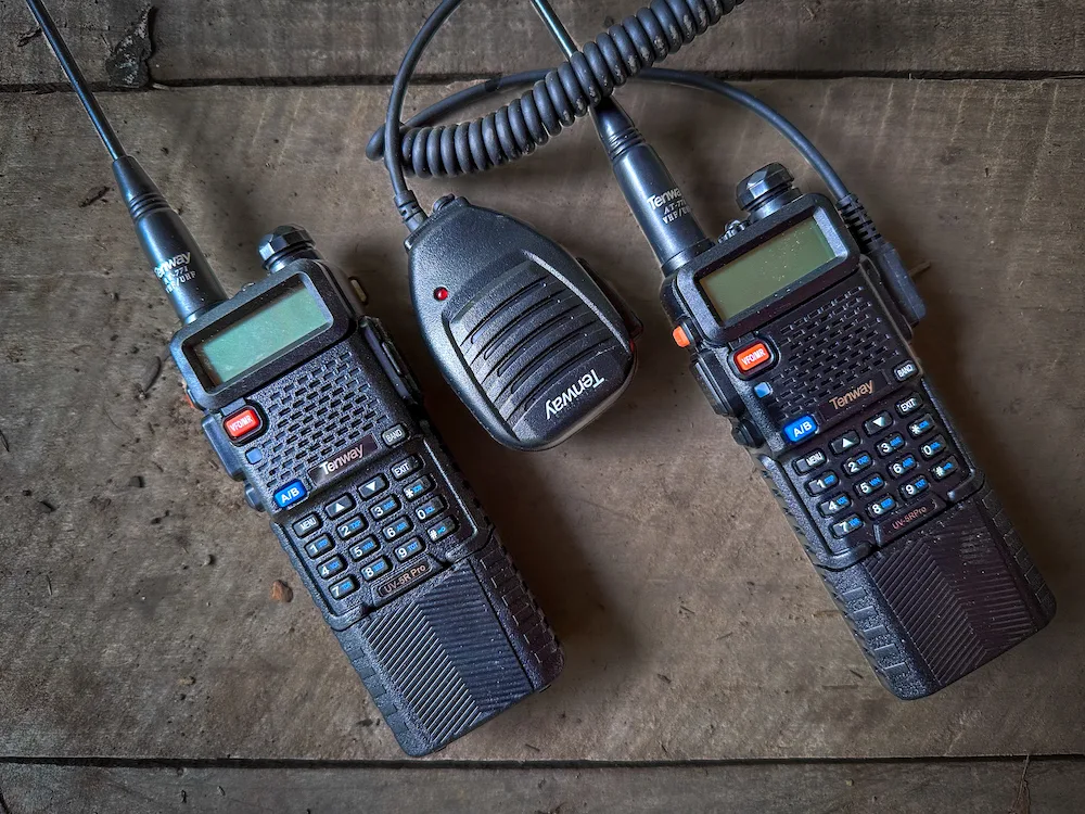 Pair of Baofeng Walkie Talkies on table during testing