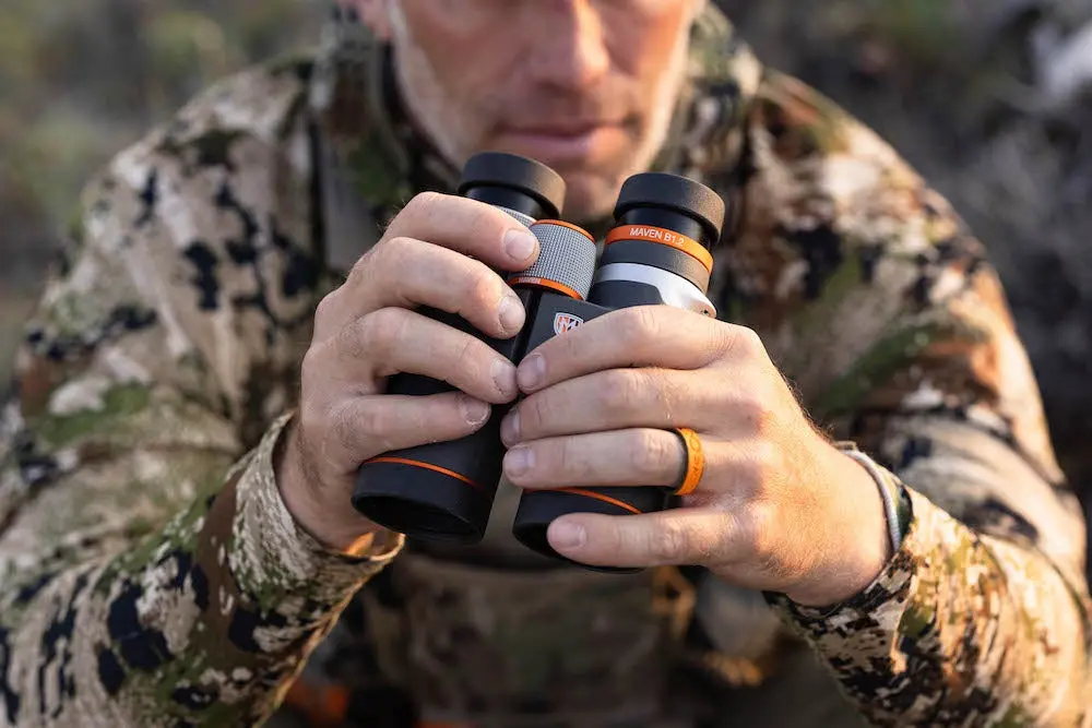 Hunter holding Maven B1.2 Binoculars