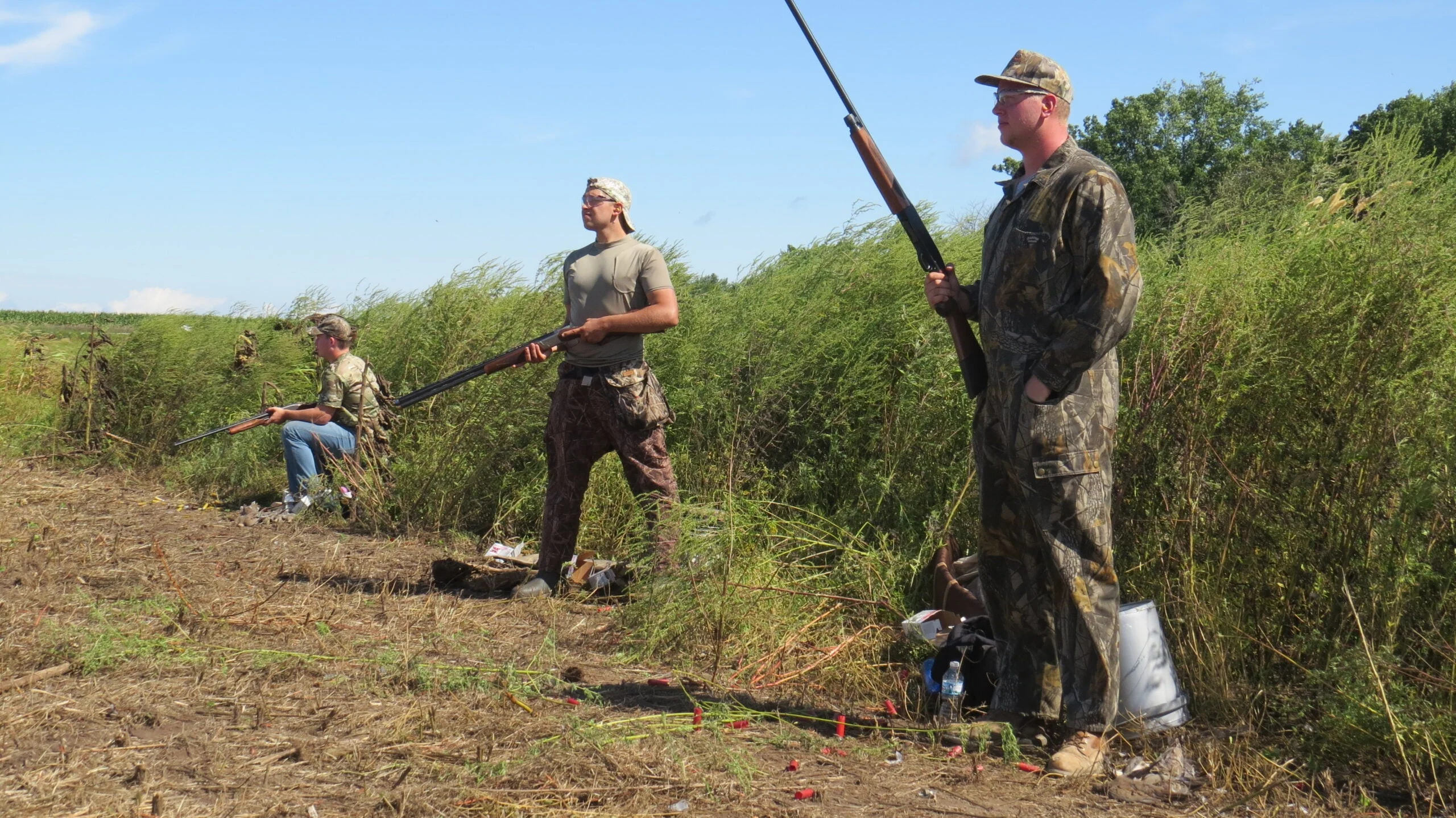 A group of men dove hunting in a field. 