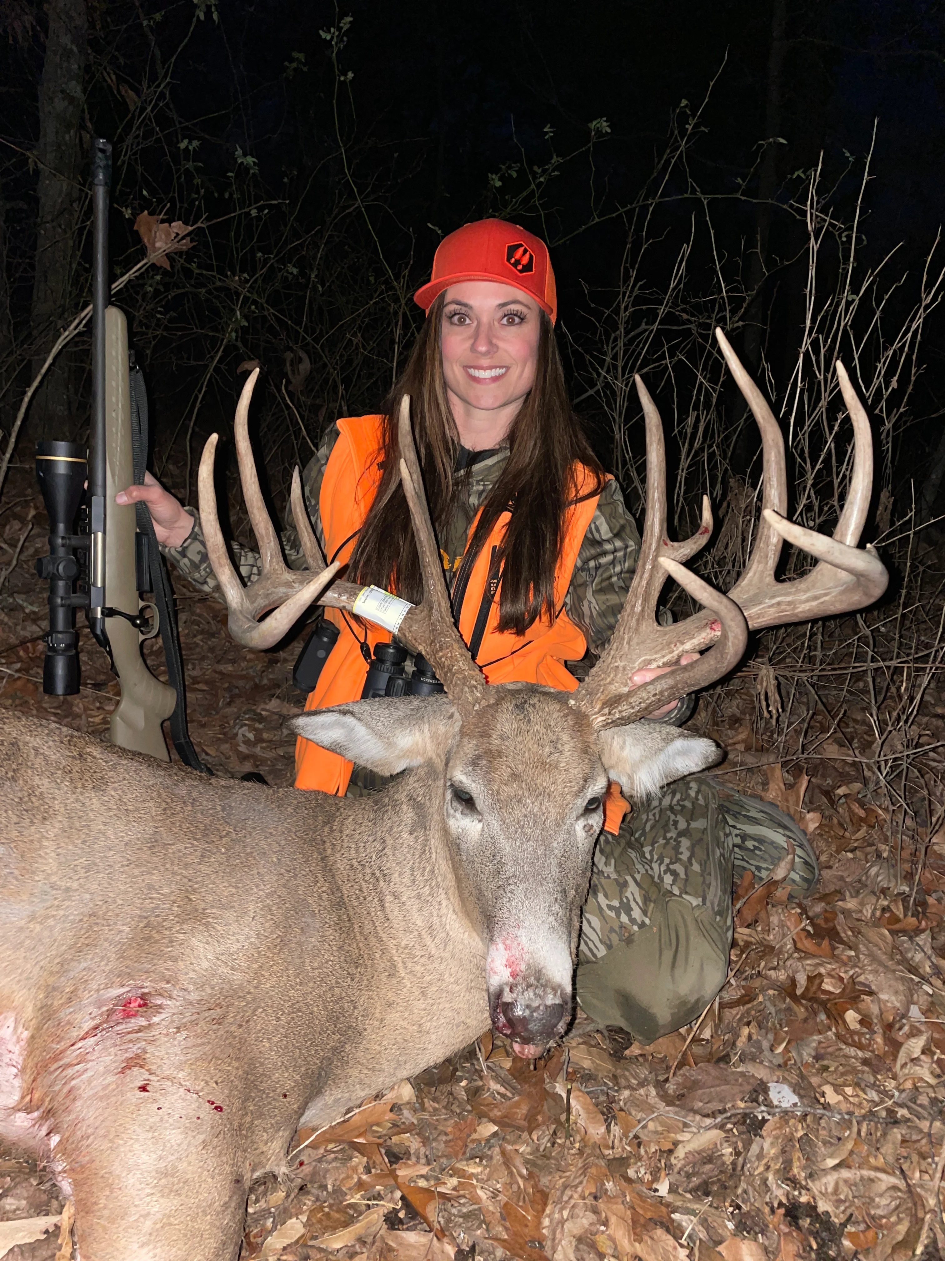 TV host Dawn Jensen poses with a huge whitetail buck taken with a rifle. 