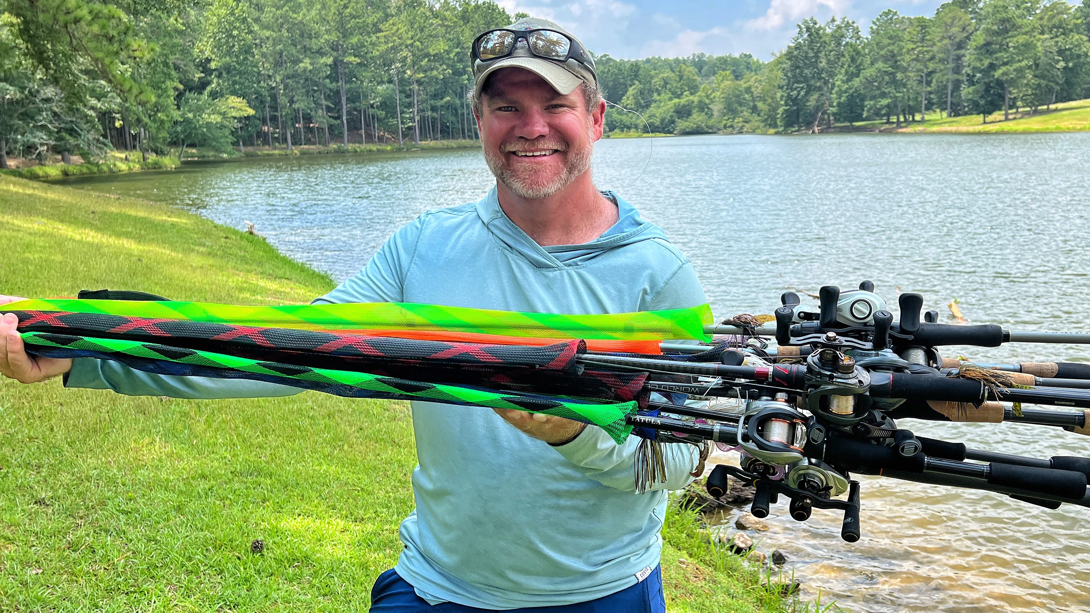 Fisherman holds up a pile of fishing rods