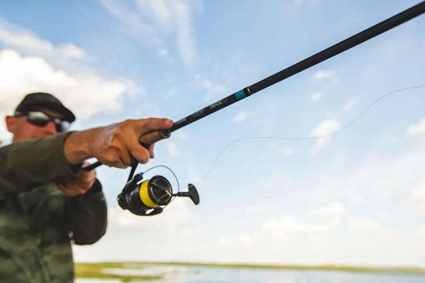 Angler casting a spinning reel