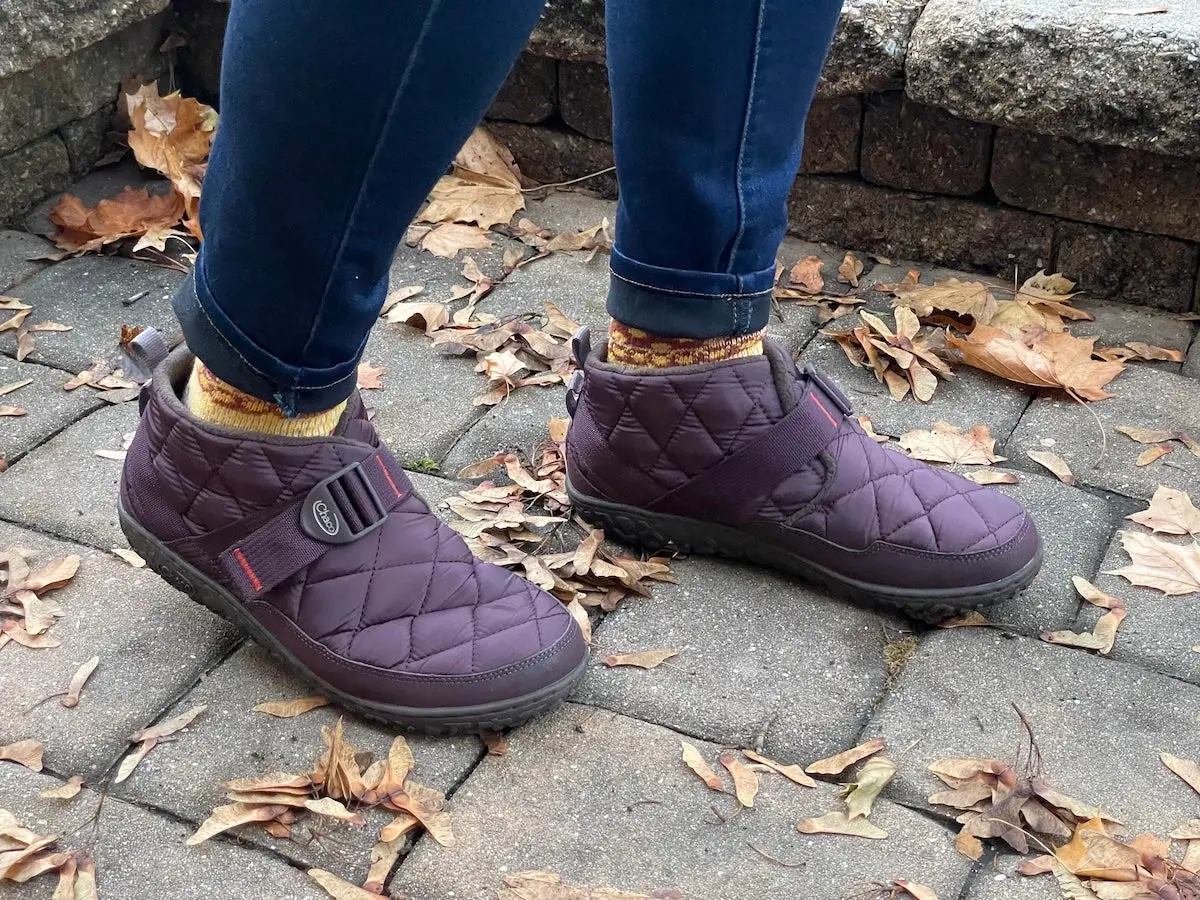 Woman wearing Chaco Ramble Puff Slippers outside