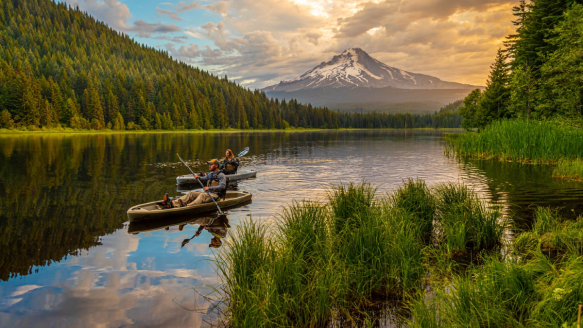 Two people kayaking on a mountain river