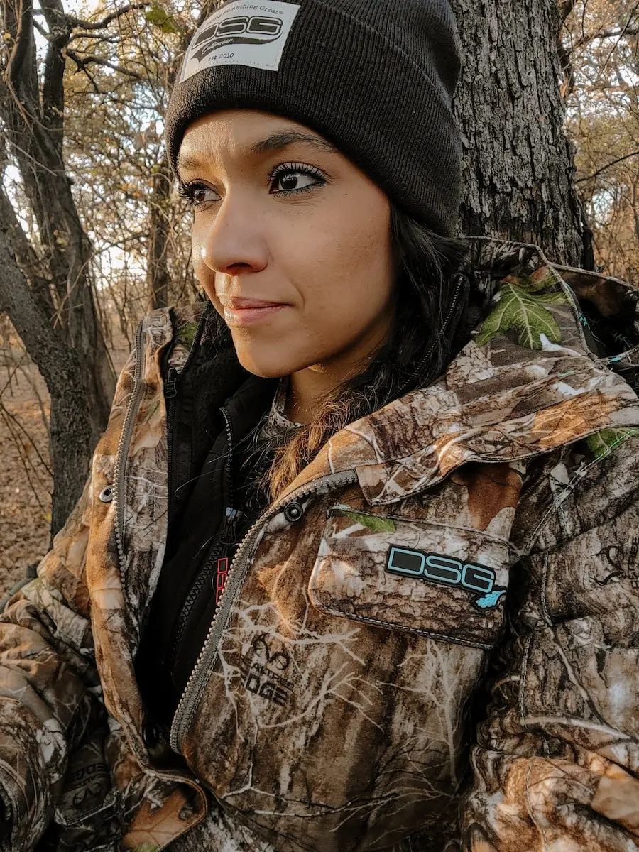 Female hunter wearing DSG Kylie 3-in-1 Jacket in the woods