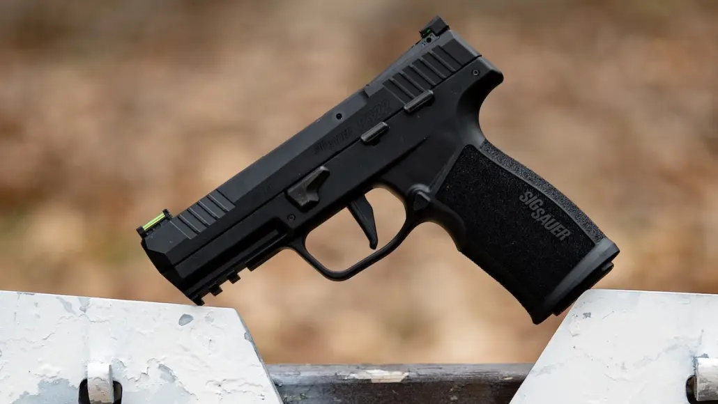 A handgun sitting on a target hanger.