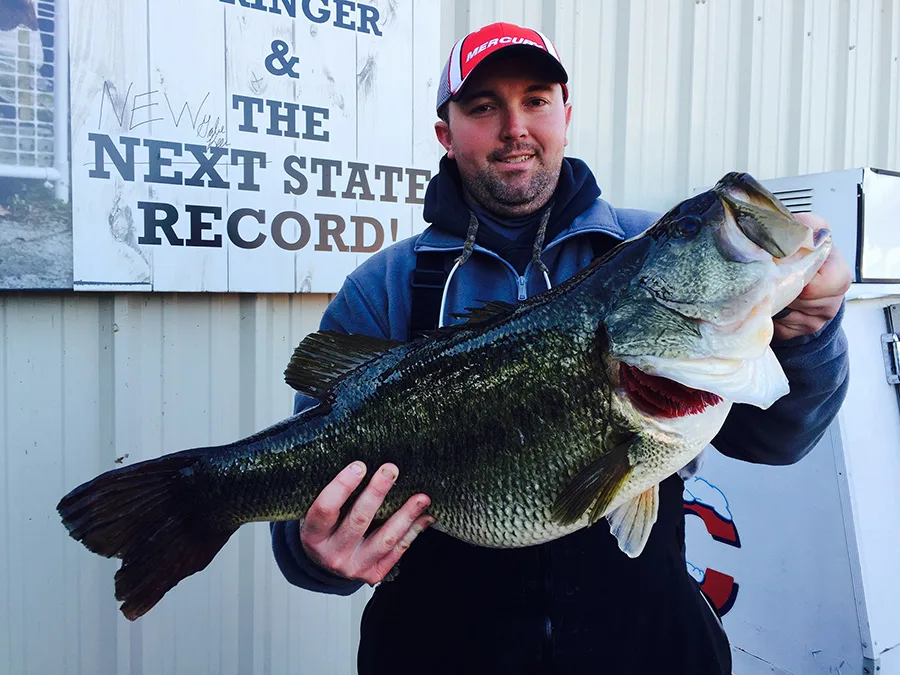 An angler poses with the Tennessee state-record largemouth bass. 