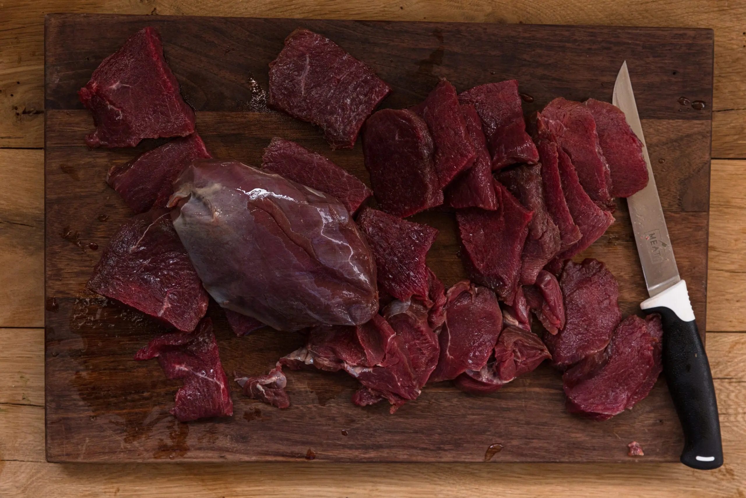 Photo of hand-cut meat being prepared for dehydration